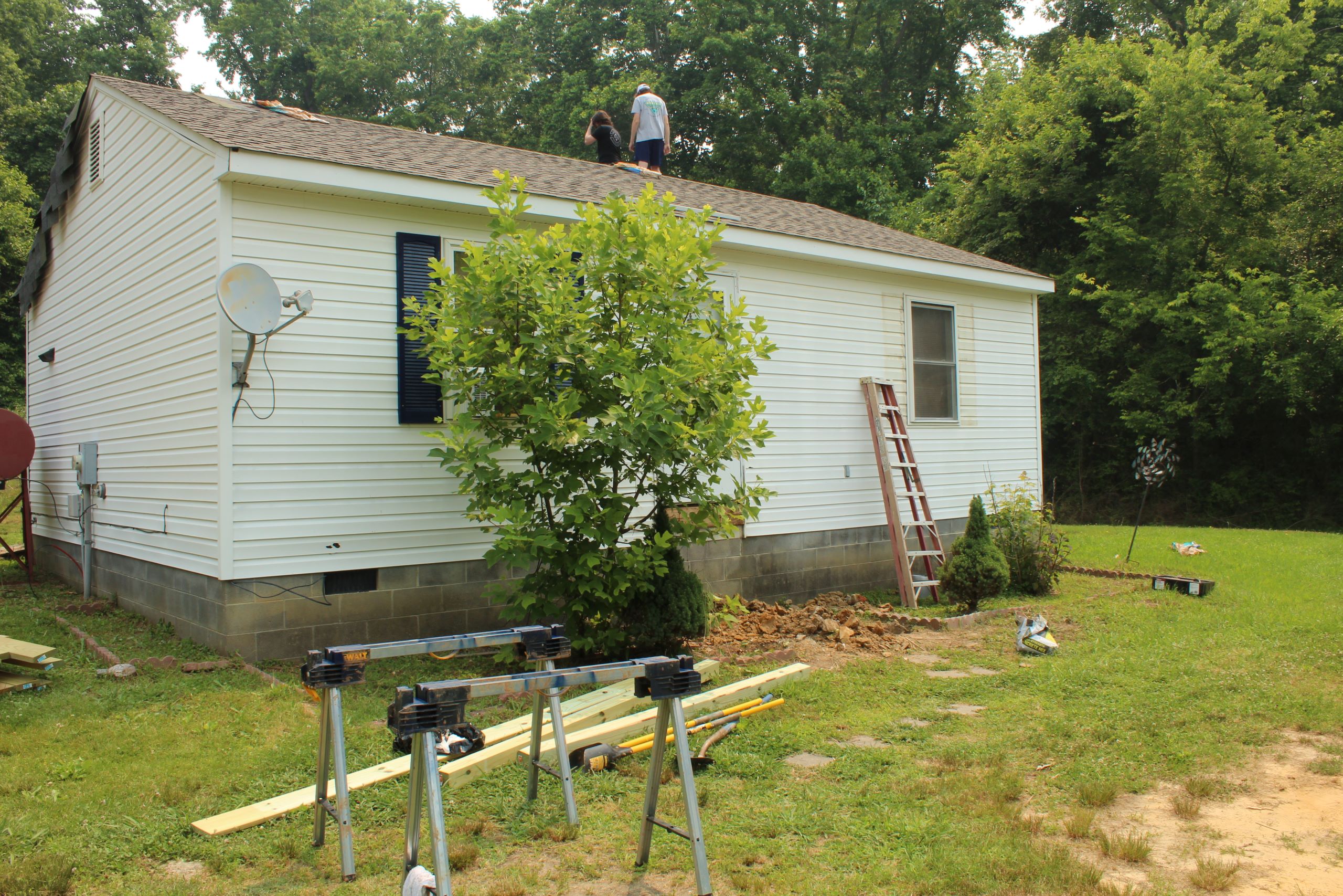 Whitehouse with front stoop being repaird