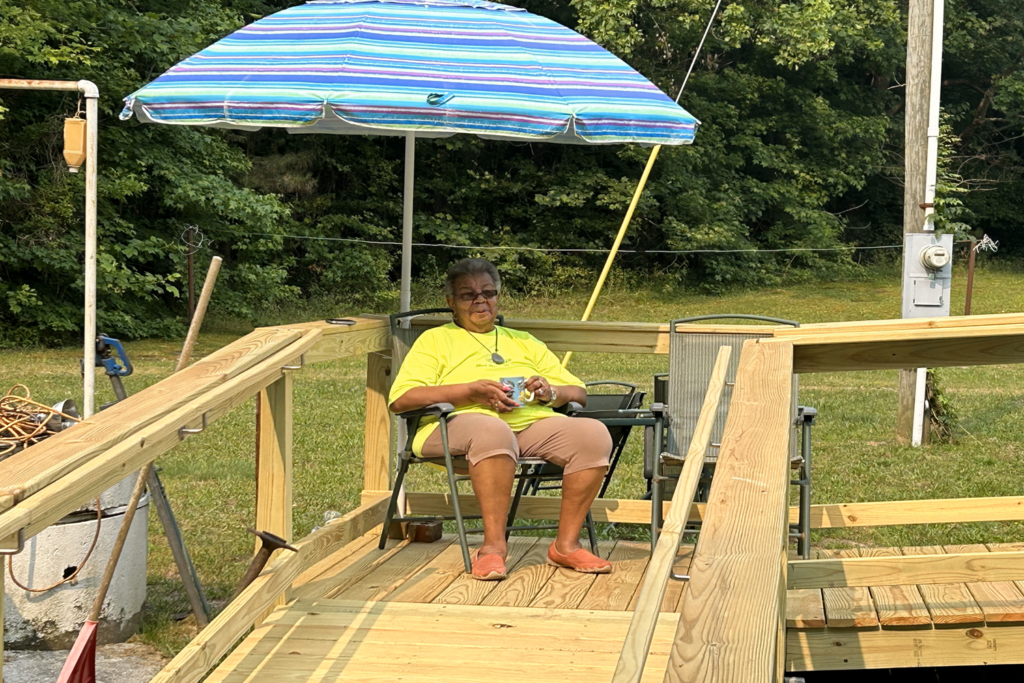 LADY SITTING ON WHEELCHAIR RAMP