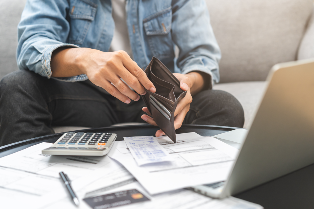 Man holding wallet while paying his bills